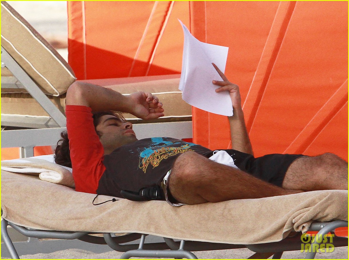 Full Sized Photo of adrian grenier shirtless beach reading 